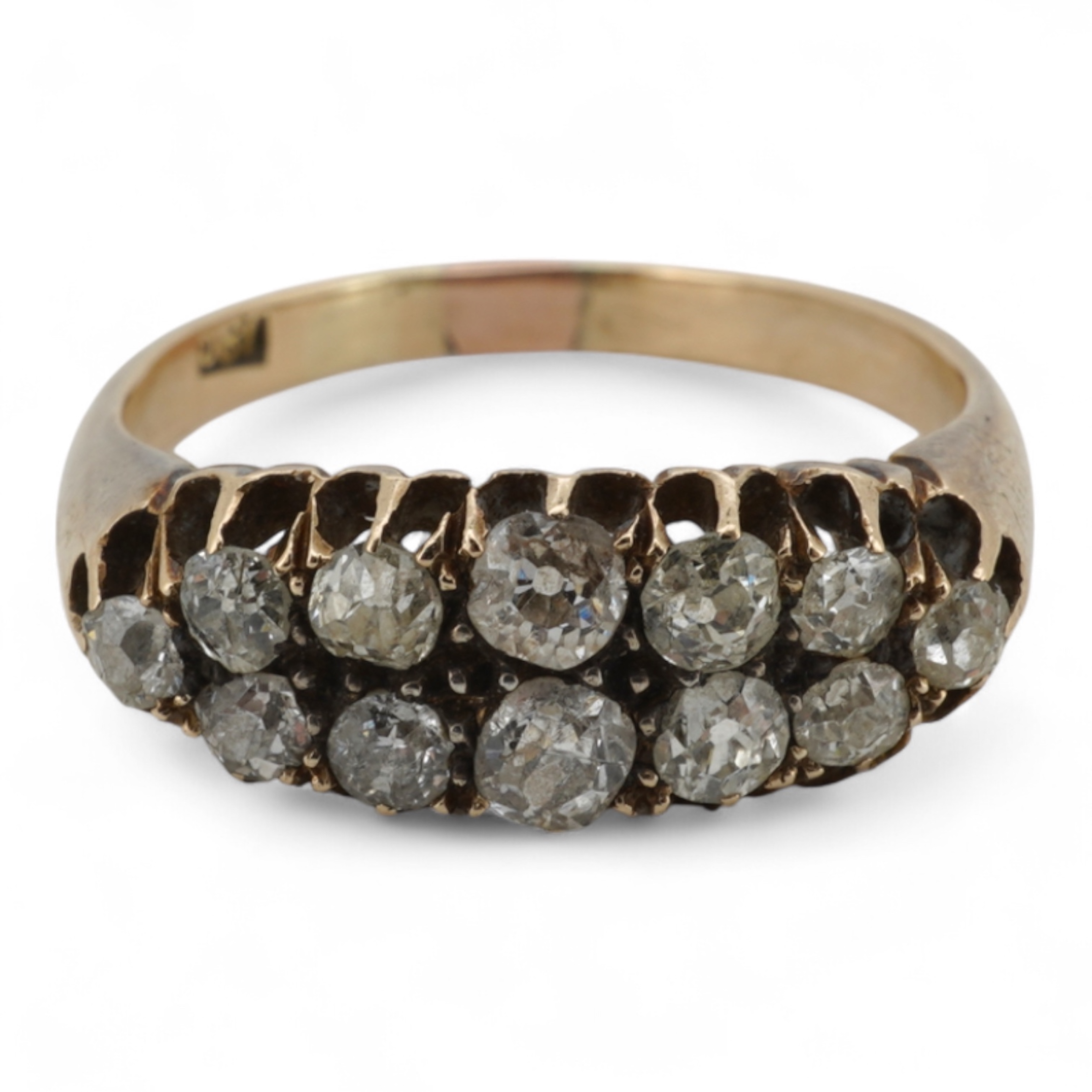 A diamond ring, early 20th century, pavé-set to the front with two rows of cushion-shaped diamonds totalling approximately 0.40 carats, mounted in gold, size O, gross weight approximately 3.5 grams